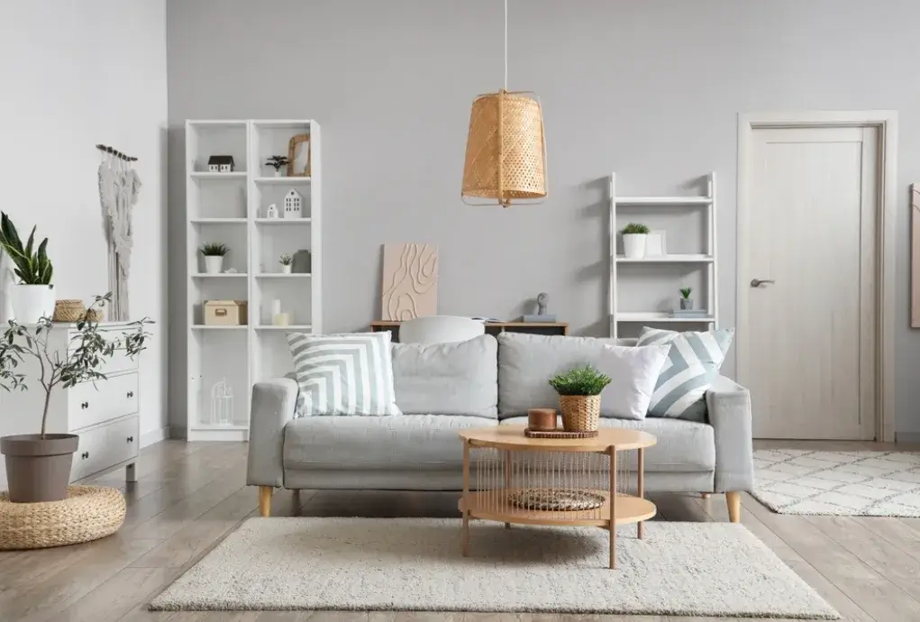 Minimalist Scandinavian-style living room with grey sofa and wooden furniture
