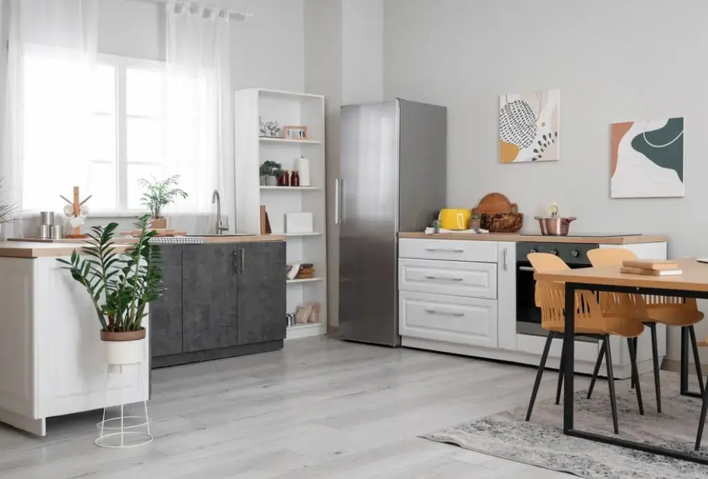 Contemporary open kitchen and dining space with white cabinetry and modern decor